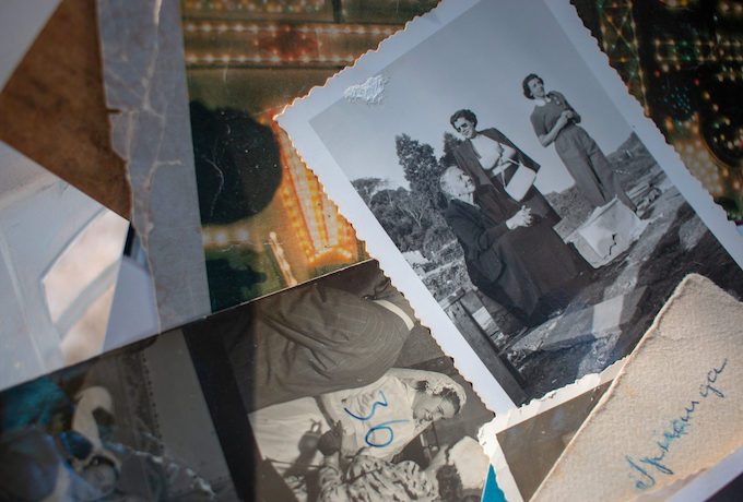 Photograph of old family pictures laid out on a table